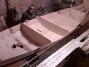 canoe building. Seat supports being stitched in place