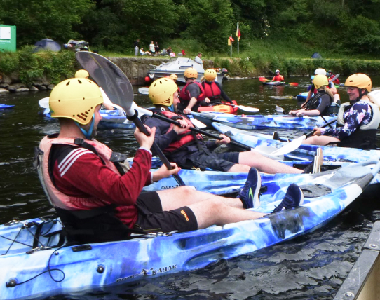 team-members-riding-kayak-together